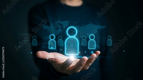 Professional Businessman Holding Digital Interface Representing Human Resource Management and Global Corporate Networking Strategy in Dark Cinematic Style