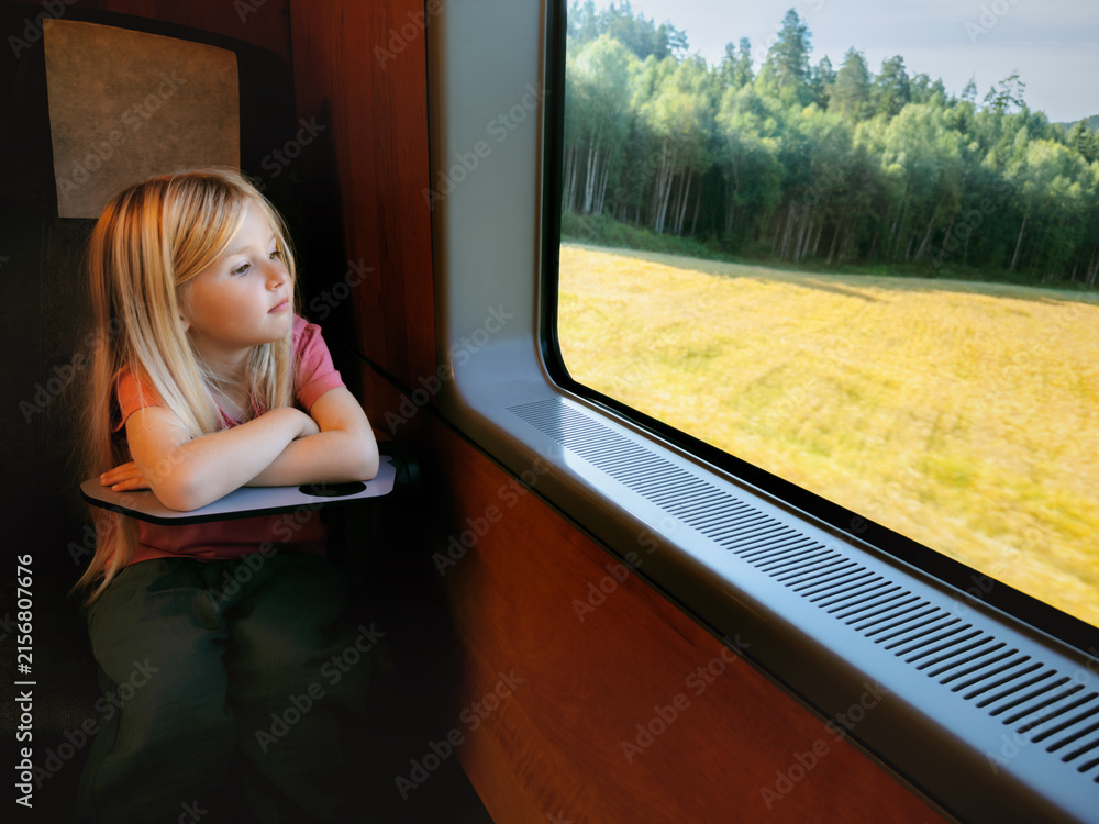 Fototapeta premium Child girl travel by train kid passenger looking at window and thinking enjoying nature view summer family vacations lifestyle, people using railway public transport