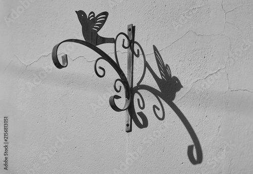 Metal art decor on the stone wall and its shade