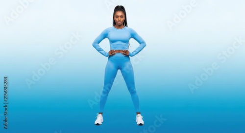 Athletic Woman in Bright Blue Activewear Standing Confidently