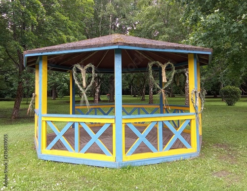 Colorful Wooden Park Gazebo with Rustic Woven Straw Heart Decorations.


