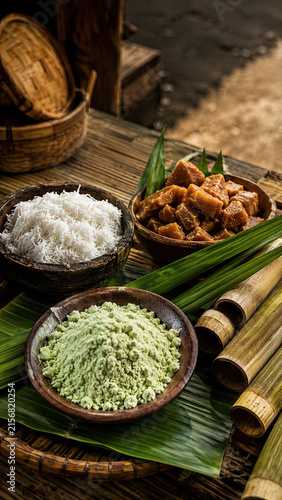 Plate of green kue putu with grated coconut and palm sugar served on a banana leaf.generative AI