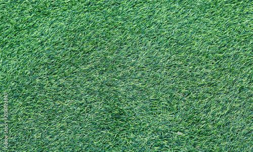 Quadro su tela Full frame background view of dense artificial green grass turf.