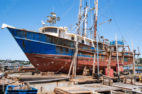 Commercial Fishing Boat Maintenance:  A deep-sea fishing vessel sits for repairs at a shipyard drydock in New England.
