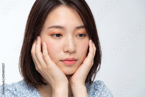 Young Asian Woman Touching Face for Skincare Routine