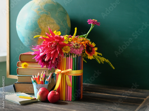 school stationery, apples, flowers, books, globe on table against chalkboard. Education, back to school, beginning of the school year, Teacher's day, Knowledge Day, 1 September concept. copy space