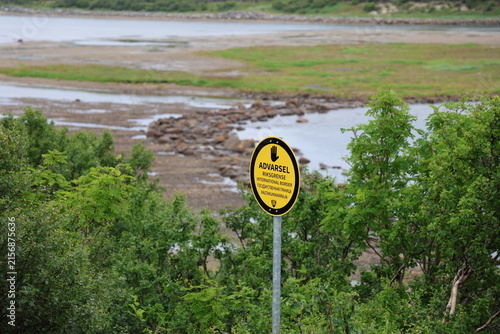 Obraz na płótnie Yellow border marker viewed from the Norwegian side near the Norway-Russia border