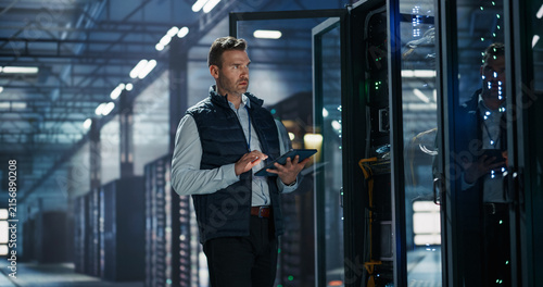 Fotografie Portrait of Caucasian Male Data Center Technician Standing Beside Open Server Ra