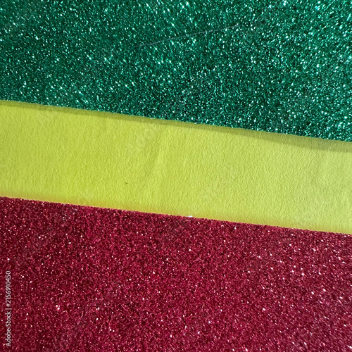 Green and red glitter paper strips separated by a yellow felt band