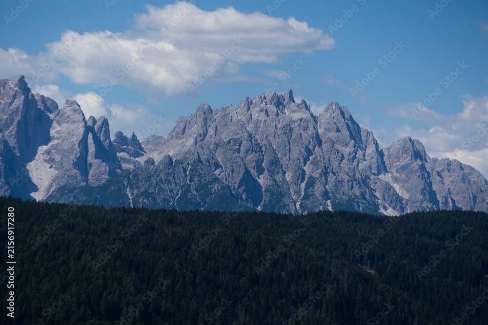 Naklejka premium Majestic scenery of rough mountain ridge near grassy hills 