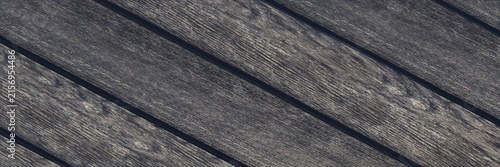 Weathered wooden planks creating a dark rustic background with visible grain