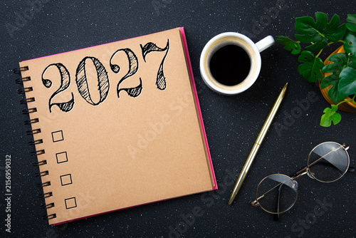 New year goals 2027 on desk. 2027 resolutions list with notebook, plant on black table. Resolutions, plan, goals, action, checklist, idea concept. New Year 2027 resolutions, copy space