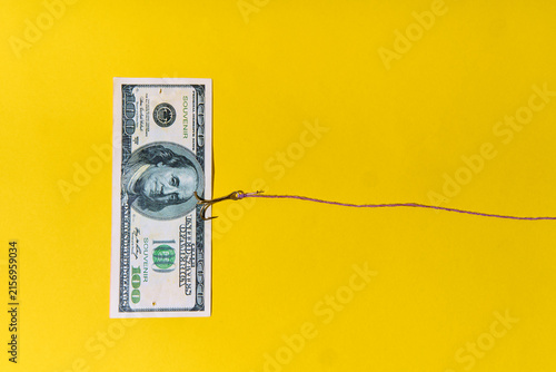 Hundred dollar bill on fishing hook