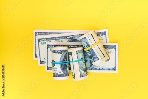 Stack and rolls of hundred dollar bills