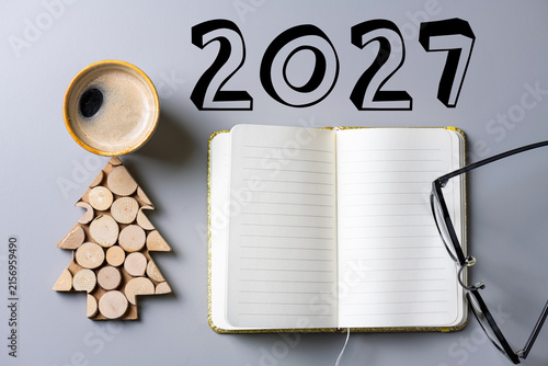 2027 New year resolutions on desk. 2027 goals list with notebook, coffee cup, plant on table. Resolutions, plan, goals, action, checklist, idea concept. New Year 2027 resolutions. Copy space