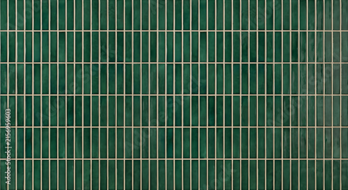 Seamless glossy emerald green vertical mosaic finger tiles wall surface with light beige grout lines