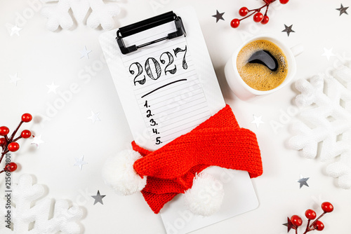 New year resolutions 2027 on desk. 2027 goals list with notebook, coffee cup on white table. Resolutions, plan, goals, action, checklist, idea concept. New Year 2027 resolutions, copy space