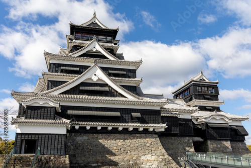 Traditional Japanese Kumamoto Castle with Black and White Architecture Under Blue Sky