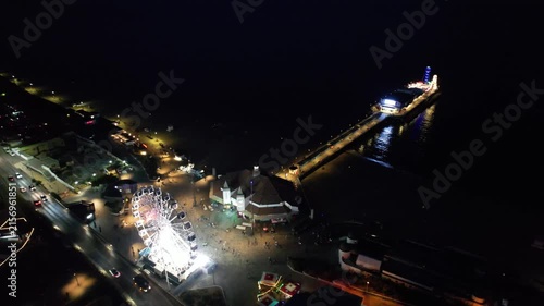 High Angle Night Footage of Illuminated Buildings and Roads with Traffic at Best Tourist Attraction Destination of England at Bournemouth City with Sandy Beach and Ocean of Great Britain, 