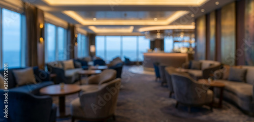 Sophisticated cruise ship lounge interior fully blurred with comfortable seating, warm architectural lighting and spacious hospitality design for travel vacation and luxury tourism