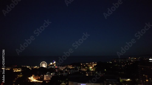 High Angle Night Footage of Illuminated Buildings and Roads with Traffic at Best Tourist Attraction Destination of England at Bournemouth City with Sandy Beach and Ocean of Great Britain, 
