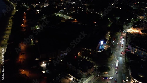 High Angle Night Footage of Illuminated Buildings and Roads with Traffic at Best Tourist Attraction Destination of England at Bournemouth City with Sandy Beach and Ocean of Great Britain, 