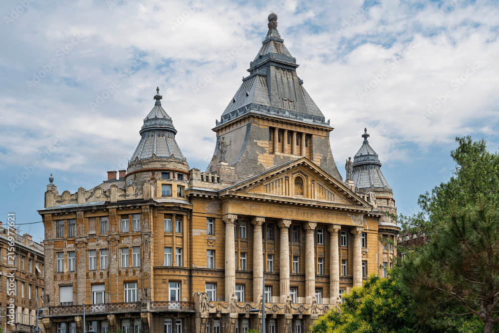 Fototapeta premium Full facade of Anker Palace with metal-clad towers and classical columns in central Budapest, Hungary