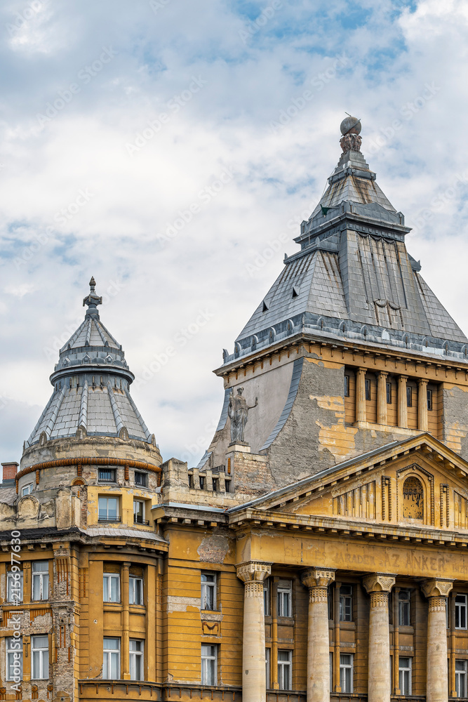 Fototapeta premium Upper facade and rooftop towers of Anker Palace seen from Deak Ferenc Square in central Budapest, Hungary