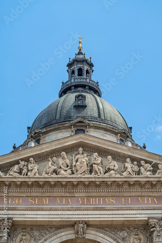 Bild auf Leinwand Sculpted pediment relief above the Latin inscription on the facade of Saint Step