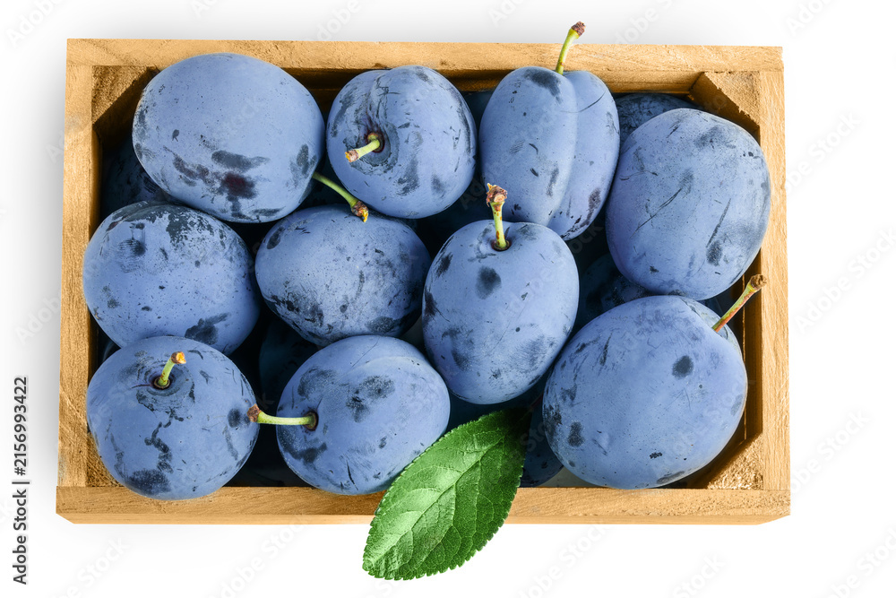 Fototapeta premium fresh blue plum in wooden box isolated on white background. Top view. Flat lay