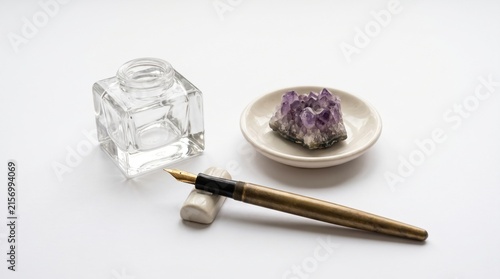 Elegant Writing Setup with Antique Pen, Ink, Crystal, and Minimalist Plate