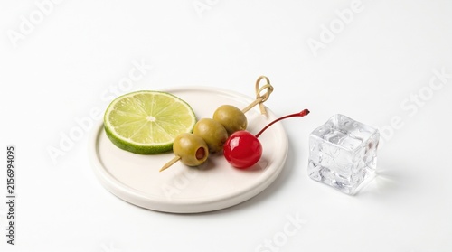 Fresh Lime Slice with Green Olives, Cherry, and Ice Cube on White Plate