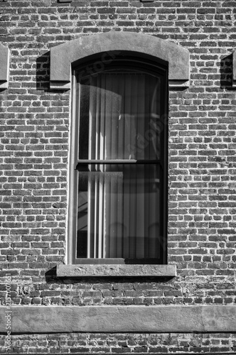 Arched Window on an Old Brick Building with Facade.