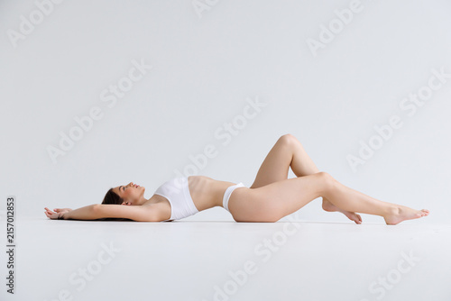 Fotografie Full length young woman with fit body wear lingerie underwear sit with long legs