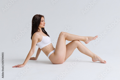 Obraz na plátně Full length young woman with fit body perfect skin wear lingerie underwear sit w