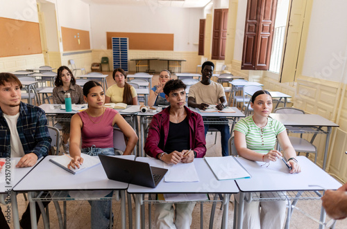 Diverse students learning in classroom, focusing on education