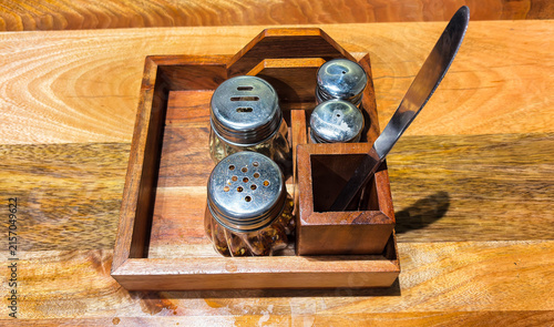 Wooden Spice Tray With Salt Pepper And Seasoning Containers On Dining Table