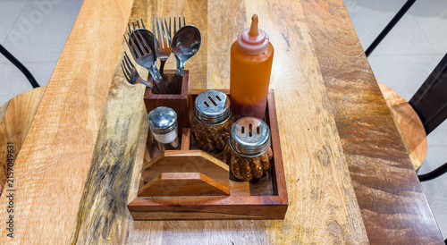 Restaurant Dining Table Setup With Cutlery Sauce and Seasoning Shakers