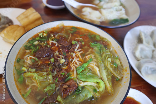 Canvastavla Bowl of beef noodles soup with lettuce and green onion as breakfast served in a