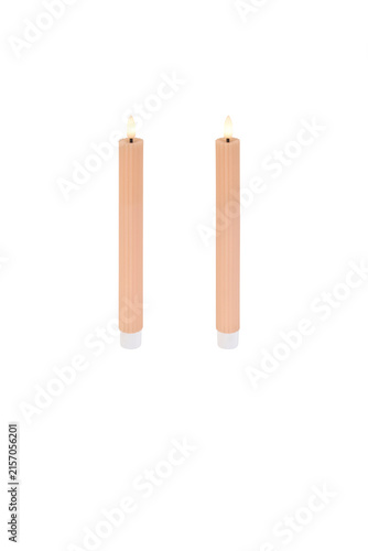 Fotografie Two tall light pink ribbed flameless led taper candles standing upright with glo