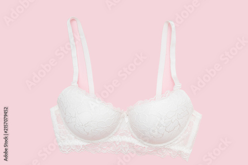White lace bra for women on a pink background. Women's lingerie.