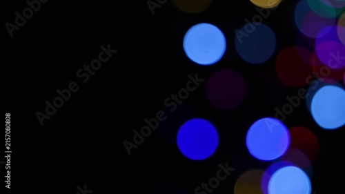 Abstract colorful blurred lights on a dark background, with glowing circles in blue red yellow and purple, Colorful bokeh lights on black background