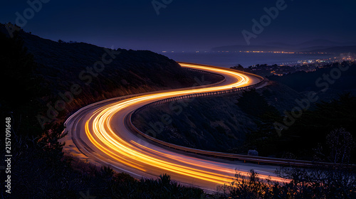 Curving highway at night showcasing captivating light trails from vehicles.