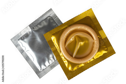 Two opened condom packages one silver one gold showing a rolled condom on black