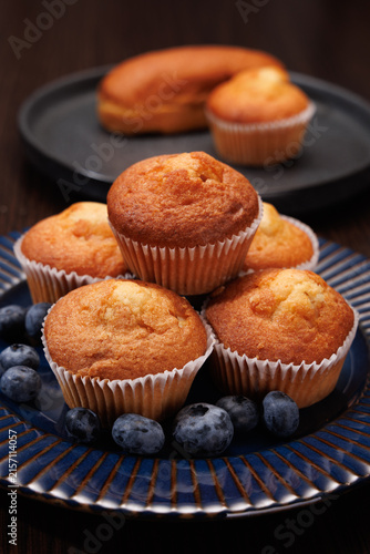 Stacked muffins with blueberries on a plate, shallow depth of field