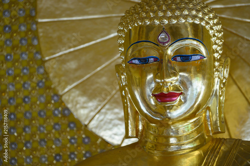 Golden Buddha Face Close Up with Copy Space in Thai Buddhist Temple
