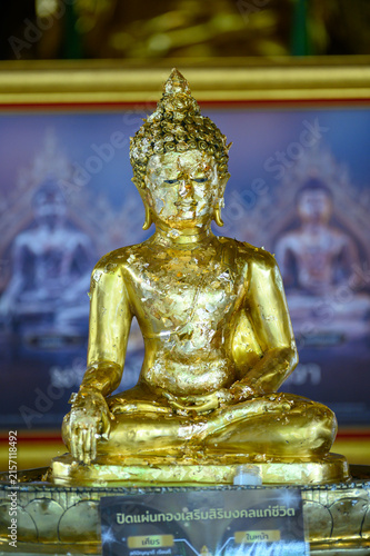 Gilded Buddha Statue Covered with Gold Leaf in Thai Buddhist Temple