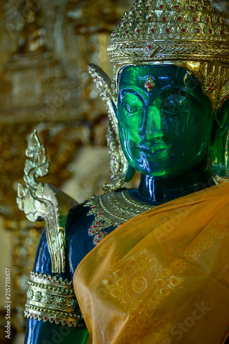 Green Buddha Statue in Ornate Golden Attire with Saffron Robe