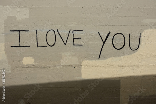 Bild auf Leinwand “I Love You” graffiti handwritten on a bright yellow wall, creating a simple urban message of love and affection with bold color, texture, and street art character