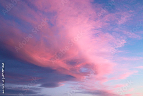 Photography Pink clouds against a blue sky at sunset.